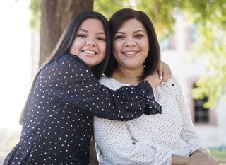 Mom and daughter smiling