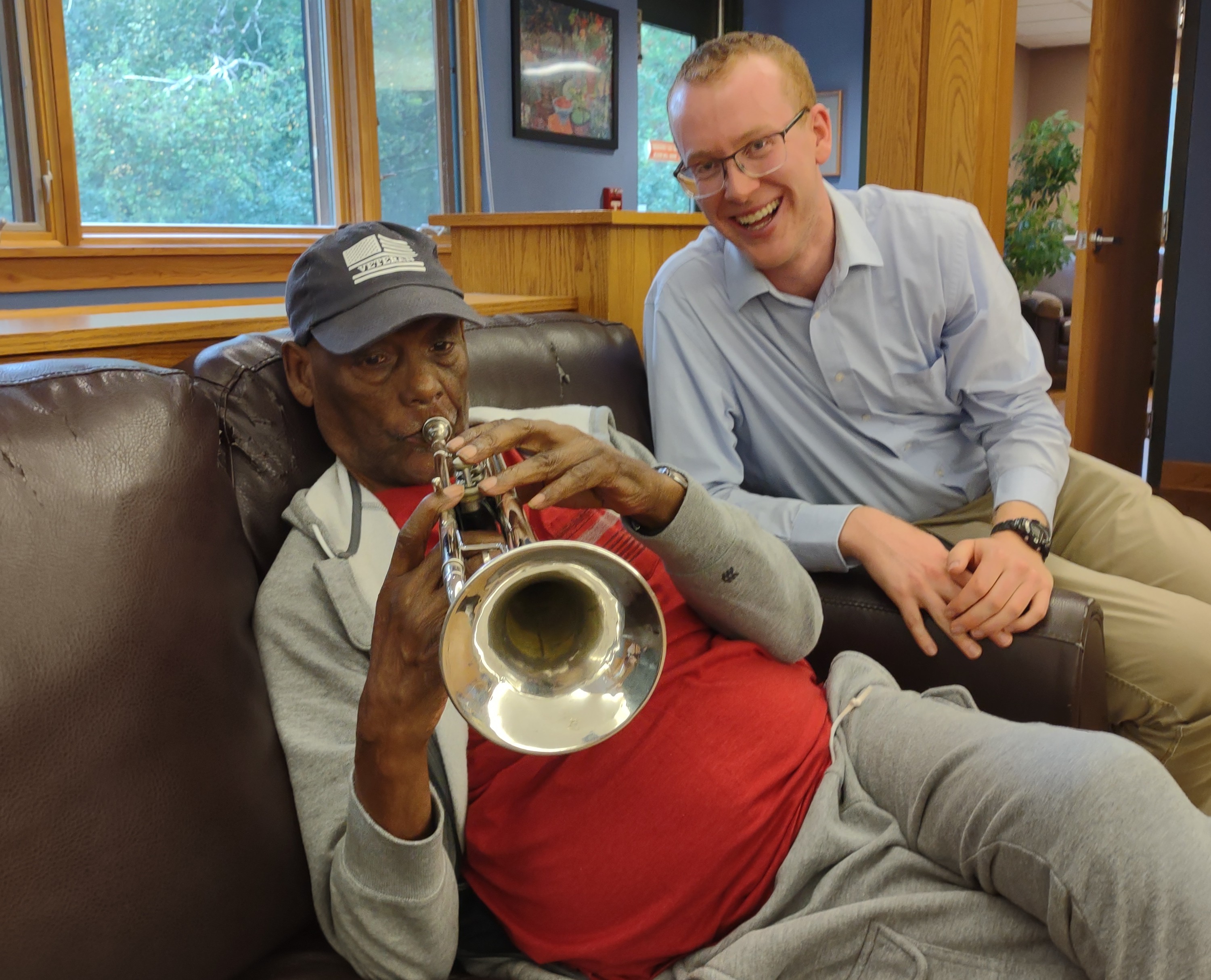 Man playing the trumpet with volunteer